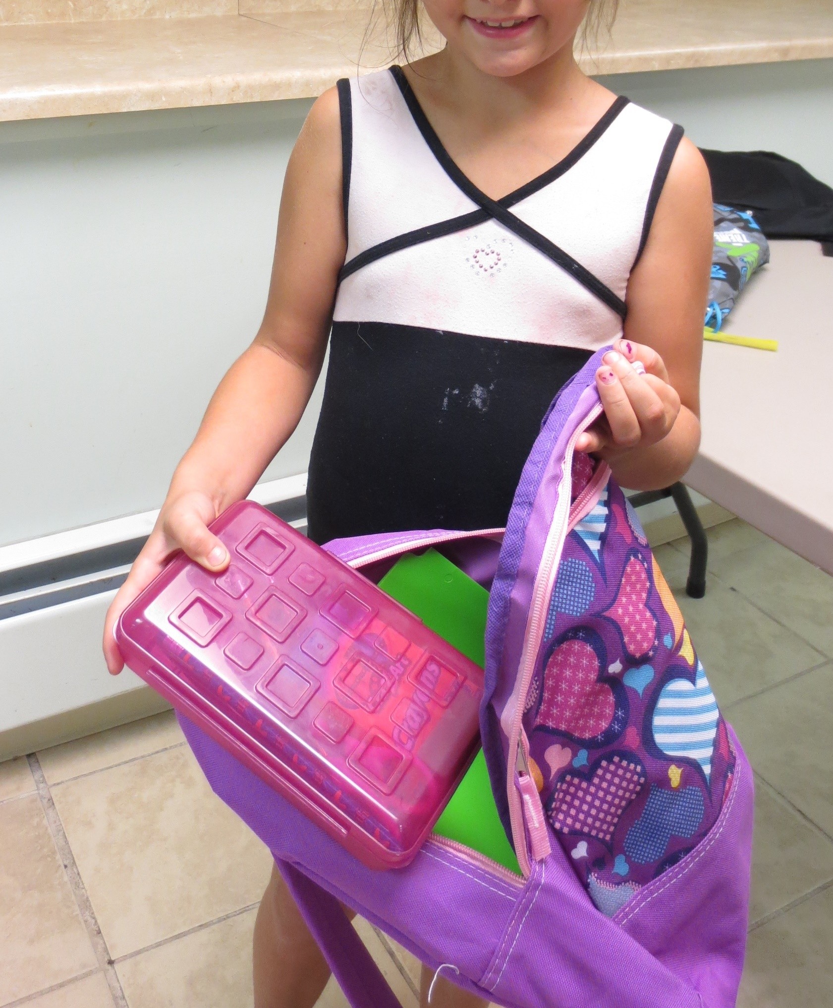 Trinity Brannock looks at the pencil box in her backpack cropped